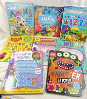 Front view of 7 children's activity books including sticker and craft themes