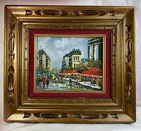Frontal view of the framed oil painting showing the Paris street scene and the entire wooden frame.