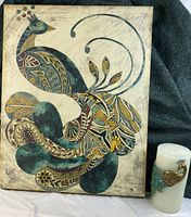 Photo showing the peacock canvas print and Pier 1 candle together for lot overview.
