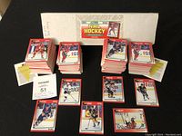 Two full sets of hockey cards in stacks with box and checklist visible