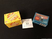 Two sealed hockey card sets boxes, yellow 1990 Rookie & Traded set and blue 1991 Young Superstars set on black background.