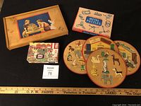 Lot arranged showing 4 items: wooden block set tray with cover, Chad Valley metal puzzles box, four round wooden puzzles, Beetle Bailey comic puzzle.