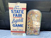 Original cardboard box with 'Deluxe State Fair Bagatelle Game' label and manufacturer info.