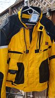 Front view of a yellow and black motorcycle jacket by Spidi, size 2XL, showing zippered front, multiple pockets, and collar detail.