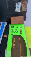 Photo showing display of various Navy pins, cufflinks, patch, and necktie alongside a wooden box labeled United States Navy