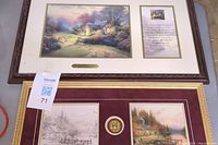 Full view of two framed Thomas Kinkade artworks: the cottage painting and the dual-image painting with medallion, each with descriptive plaques.