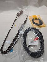 Photo showing a group of four miscellaneous cables and electronic accessories on a white background.