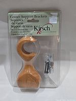 Full view of Kirsch Center Support Bracket in original packaging with screws included