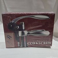 Front view of professional corkscrew in packaging showing the lever and handle design