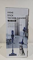 Photo of product box showing the model name, features, and image of the stick vacuum cleaner with charging station and floor brush.