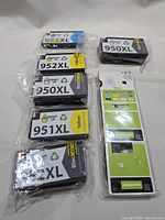 Six printer ink cartridges in packaging and a compatible information card.