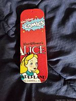 Red metal tin with Walt Disney's Alice in Wonderland comic design and Disney Comics branding.