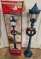 Full view of the lamp post with original packaging box showing the product image and branding.