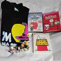 All items in the lot displayed: T-shirt, three DVDs and four Peanuts character ornaments.