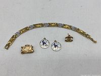Lot of 5 vintage jewelry pieces including bracelet, pendants, and earring displayed together on white background.