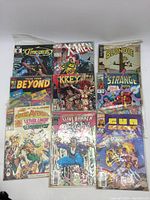 Overview image of all 9 comics showing the different titles and cover art styles.