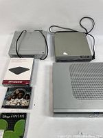 Full lot overview showing four electronic devices including DVD players, a digital receiver, the Transcend DVD writer in box, and two CDs.