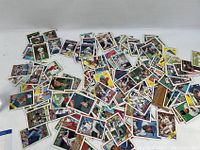 Scattered assortment of MLB baseball player trading cards showing various players and teams.