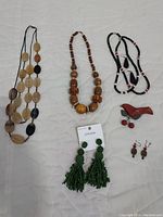 Overview of the wooden and beaded jewelry collection including necklaces, earrings, and brooch.