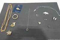 Complete layout of the jewelry collection showing all included items on a dark mat for clarity.