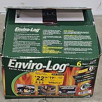 Photo of the green Enviro-Log box showing label and branding details, indicating box originally held 6 fire logs and used condition.