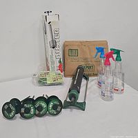 Full lot displaying plant duster in box, spray bottles, sprinkler, hose guides, lawn and leaf bags, and plant clips