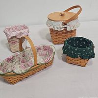Four Longaberger baskets showing different fabric liners and basket styles