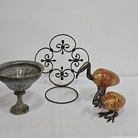 Photo showing the metal planter, the ornamental metal pedestal, and both bird sculptures placed side by side on a white background.