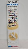 Front view of the original box showing the 50 pair shoe rack with shoes on multiple levels and text stating 50 Pair Shoe Rack and capacity.