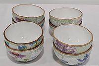 Front view of stack of 4 Herb Garden bowls showing various herb names and illustrated designs