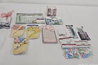 Overview of all stationery items including notepads, pens, sticky notes, and other accessories on a white surface