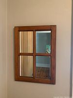 Full view of the antique solid wood mirror showing four rectangular panels separated by wooden dividers.