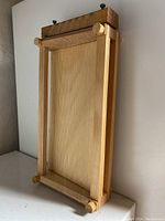 Front angled photo showing the full rectangular wooden frame with vertical cutting strings for slicing pasta dough.