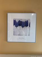 Full front view of the framed artwork showing the silver frame, white matting, and centered blue flower print.