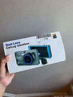 Front of box showing product image with dual lens camera and rear camera, highlighting HD 1080P main camera and 80P secondary camera.