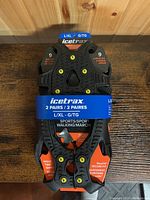 New IceTrax ice tracks for shoes in size L/XL for shoe size 9, showing front view with packaging and spikes.