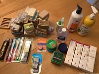 Assorted bath and personal care items arranged on table showing soaps, lotions, and dental care items