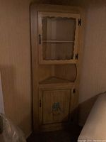 Country kitchen corner shelf with glass-front upper cabinet, wood lower cabinet with floral painting, and open shelves between