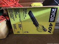 Box of Ryobi 40V 550 CFM blower kit showing model info and specs.