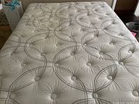 Top surface of mattress showing quilted tufted circular pattern