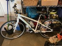 Side view of white Trek FX mountain bike leaning against shelf