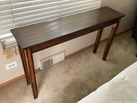 Full view of the sofa table showing its length, color and finish