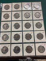 Full sleeve showing twenty 1968 Canadian fifty cent coins in individual cardboard holders.