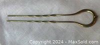 Gold filled antique Victorian 1890s hair pin with two prongs and a jump ring, shown on white background.