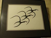 Framed limited edition print showing three stylized geese flying in formation in black and gray on a white background. Print is matted and in a black frame.