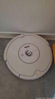 Close-up of white iRobot Roomba robotic vacuum cleaner with control buttons