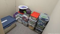 Corner view of multiple plastic bins and large tote labeled quilt batting