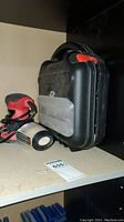 View of Skil random orbital sander, Black & Decker detail sander, and carrying case on shelf