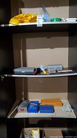 Shelf with assorted tool cases and items, overview of the lot contents