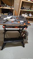 Black & Decker Workmate 550 foldable work station with vise and sandpaper sheets on top.